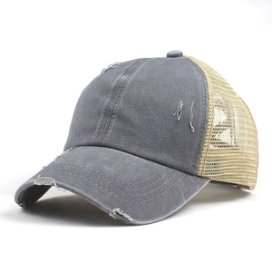 Close-up of vintage distressed mesh baseball cap with frayed edges and washed fabric