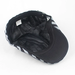 Close-up of internal 100% cotton label and black inner lining of striped beret hat