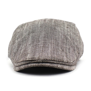 Close-up detail of grey herringbone pattern on cotton flat cap for a classic vintage style