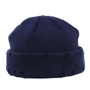 Detailed knit texture of dark blue beanie featuring a folded brim with jacquard pattern