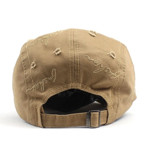 Rear view of khaki cotton beret showing vintage distressed holes and metal buckle strap