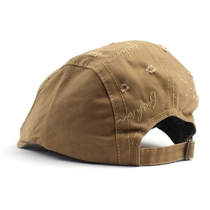 Detail view of khaki ivy cap with vintage distressed holes and fashion embroidery