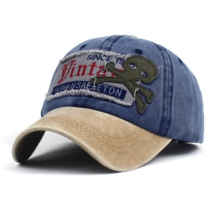 Vintage navy and khaki cotton baseball cap with embroidered letter patches and skull design