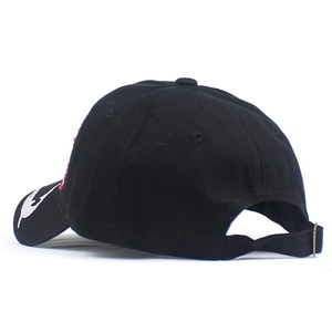 Detail of adjustable metal buckle and red embroidery on the back of the black cotton cap