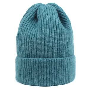 Detail of dark teal ribbed knit beanie showing thick texture and wide folded cuff