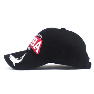 Detail view of black cotton baseball cap with shark embroidery and Aruba patch