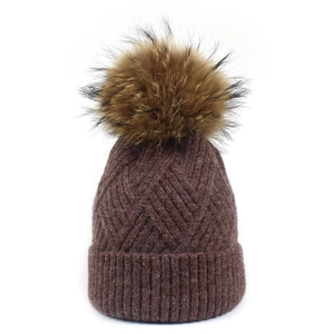 Women's warm winter knitted beanie with dark brown pom-pom and diamond texture