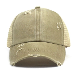 Detail of khaki washed cotton baseball cap showing vintage distressed brim and breathable mesh