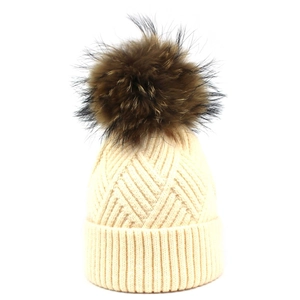 Women's cream knit beanie with large faux fur pompom for winter warmth and style