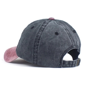 Detail view of washed cotton baseball cap with adjustable metal buckle and contrast stitching