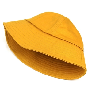 Detail of mustard yellow cotton bucket hat showing reinforced brim stitching and fabric texture