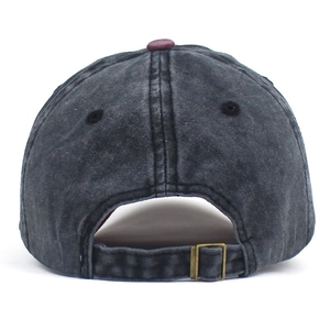 Detail of vintage washed denim baseball cap with adjustable brass metal buckle closure