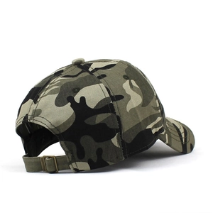 Detail of adjustable bronze metal buckle and woodland camouflage pattern on baseball cap