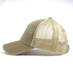 Detail view of khaki ponytail baseball cap with distressed brim and breathable mesh back