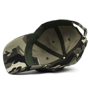 Detail of woodland camouflage baseball cap showing metal eyelets and adjustable strap