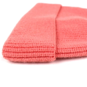 Close-up of peach-orange ribbed knit texture on a soft cashmere-like winter hat