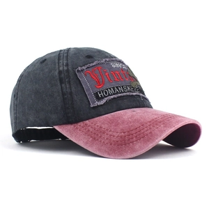 Detail of vintage washed cotton baseball cap with embroidered patch and contrast stitching