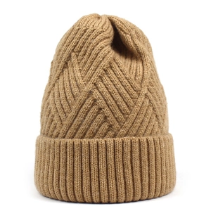 Close-up of brown knitted winter hat with geometric pattern and ribbed cuff detail