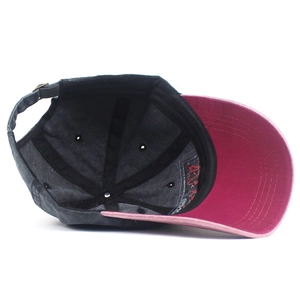 Detail of grey cotton baseball cap showing internal six-panel structure and metal buckle
