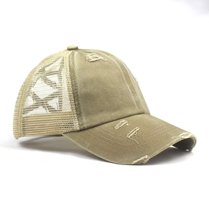 Detailed side view of khaki distressed mesh trucker hat with torn brim and vintage look