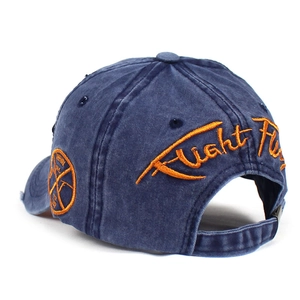Detail of adjustable metal buckle and orange embroidery on washed cotton baseball cap