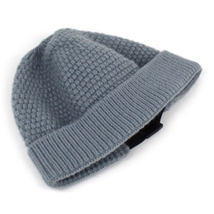 Detail of gray-blue chunky knit beanie showing thick ribbed texture and wide folded cuff
