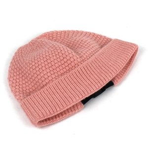 Detail of pink knitted beanie featuring thick waffle texture and wide folded brim design