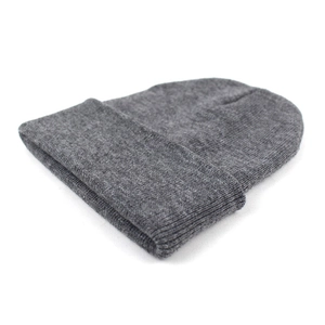 Detail of dark grey ribbed knit beanie showing thick warm fabric and classic fold cuff