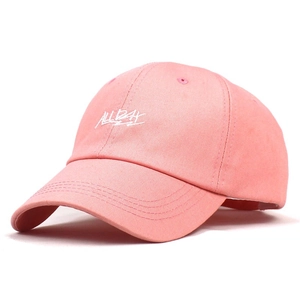 Detailed close-up of pink cotton twill baseball cap with white ALL DAY embroidery