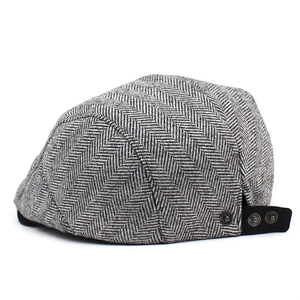 Detailed side view of grey herringbone wool flat cap with adjustable metal snap buckle