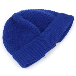 Detail of navy blue knit beanie showing thick ribbed texture and rolled edge design