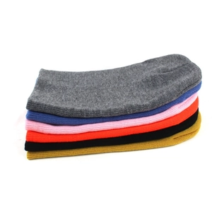 Stack of warm ribbed knit beanies for men and women available in six classic solid colors