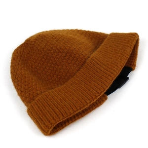 Detail of ginger yellow knitted beanie showing rib-knit texture and adjustable buckle