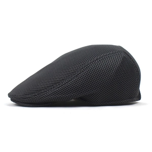 Detail view of black mesh flat cap showing breathable fabric and streamlined side profile