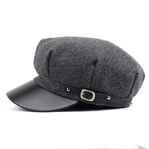 Chic dark grey wool newsboy cap with black leather brim and silver metal side buckle