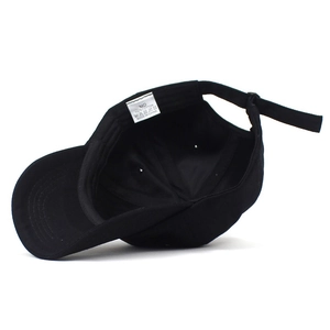 Internal view of black cotton baseball cap showing white size and care label detail