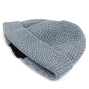 Detail of grey waffle-knit beanie showing the textured fabric and black plastic buckle strap