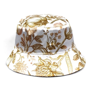 Detail of white satin fisherman hat featuring vintage pomegranate and floral patterns
