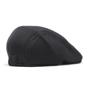 Close-up of black breathable mesh flat cap showing the lightweight knitted texture