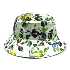 Detail of light green satin bucket hat with vivid fruit prints for summer vacation