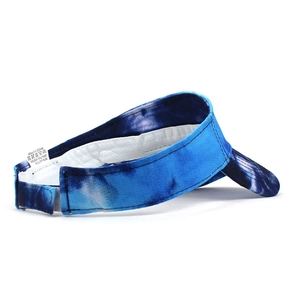 Detail view of tie-dye sun visor hat showing 80% cotton material and wash label