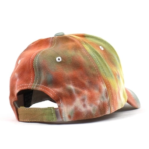Detail of multi-color tie-dye baseball cap featuring adjustable velcro strap and wash label