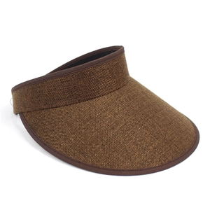 Detail of brown linen texture and dark brown ribbon edge on wide brim sun visor hat