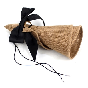 Foldable women's sun hat in woven straw with a black grosgrain bow and chin strap