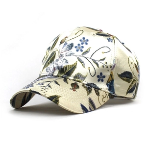 Detailed view of the elegant floral print and silk texture on the stylish baseball cap