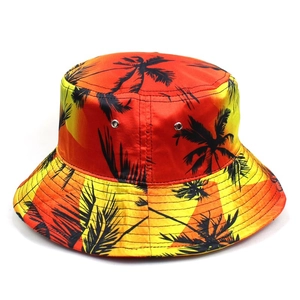 Foldable tropical gradient bucket hat with black palm tree silhouettes and metal eyelets