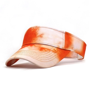Detail view of tie-dye orange sun visor with reinforced stitching on the breathable brim