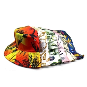 Variety of foldable women's sun hats with diverse floral and tropical prints for travel