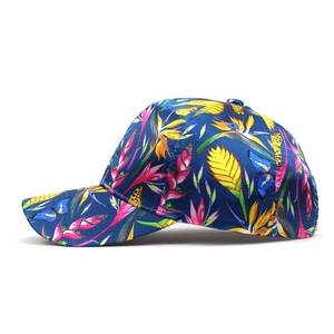 Detail of floral baseball cap showing tropical leaf patterns and colorful butterflies