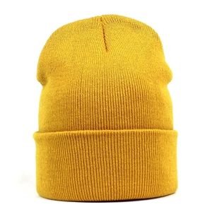 Macro shot of ginger yellow ribbed knit beanie showing fine texture and cuffed design